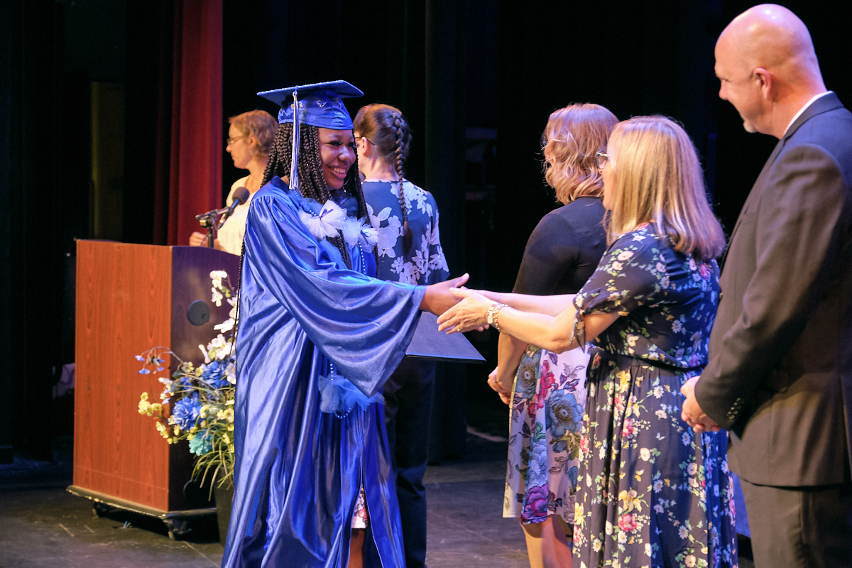 Graduate student shaking hands with a teacher image