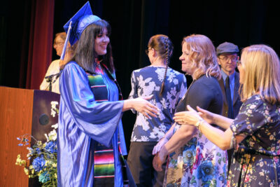 Graduate shaking hands with a teacher image