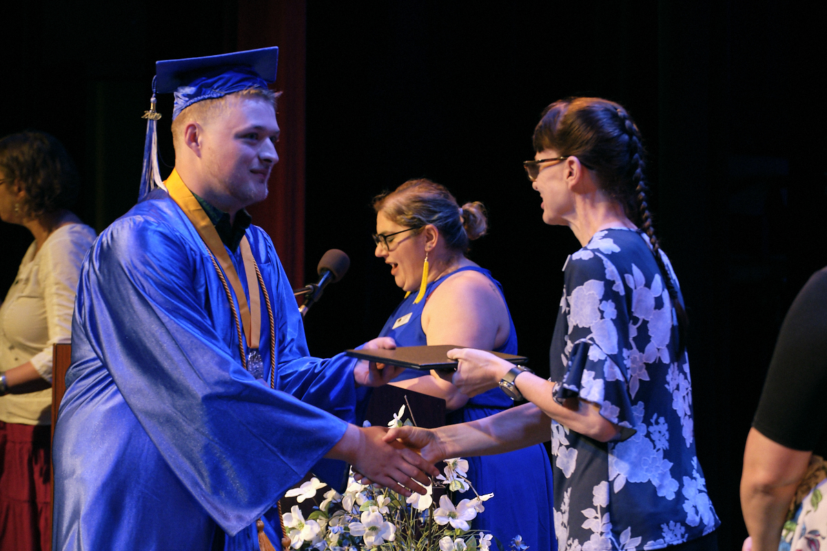 Student receiving his diploma image