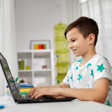 boy smiling using the computer