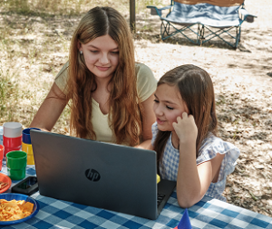 Mother and her child working together with their laptop