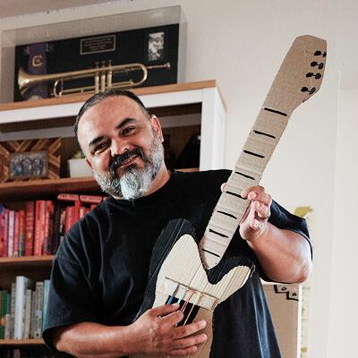 Gabriel, parent, playing his guitar